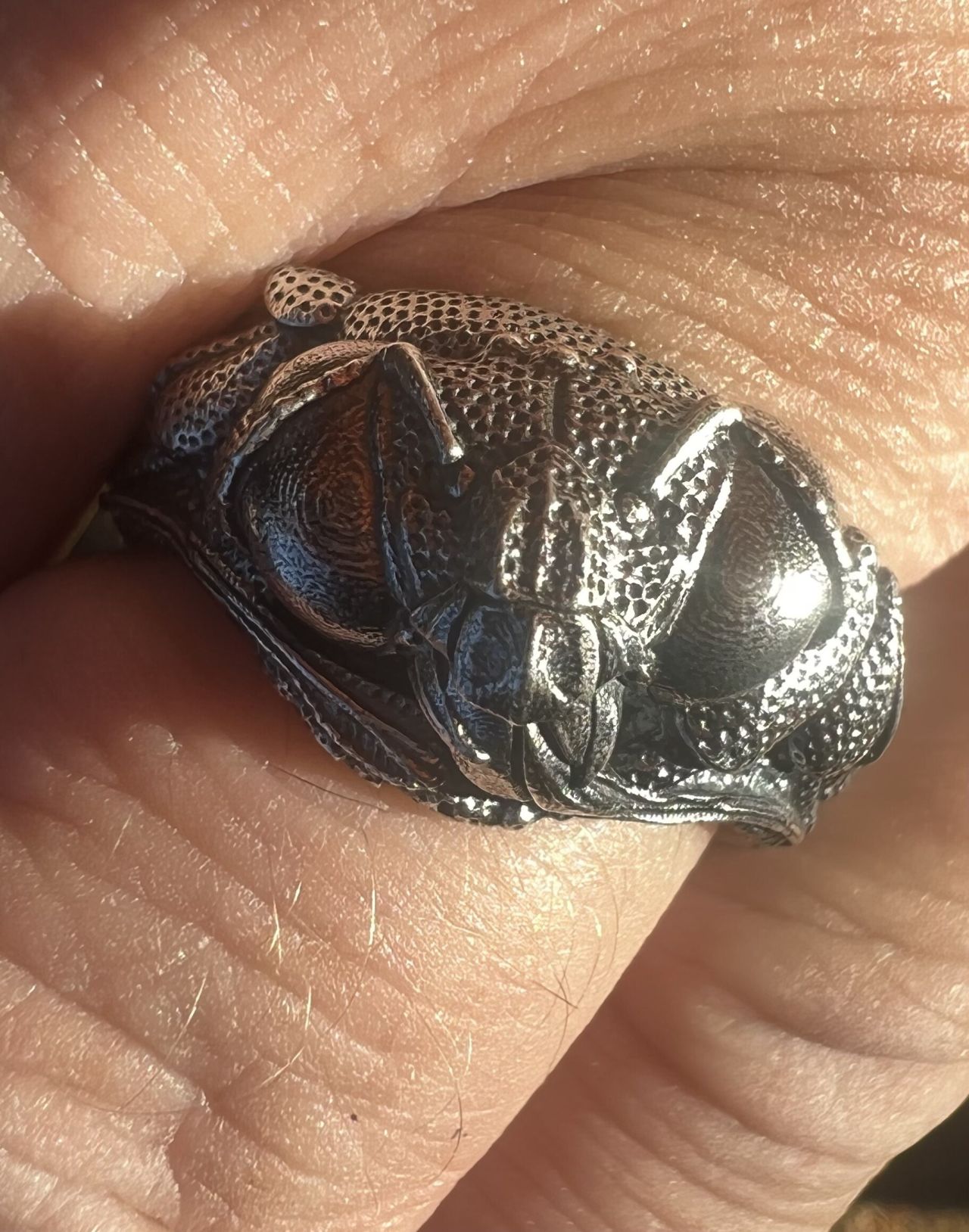 A ring based on an orchid bee cast in sterling silver.